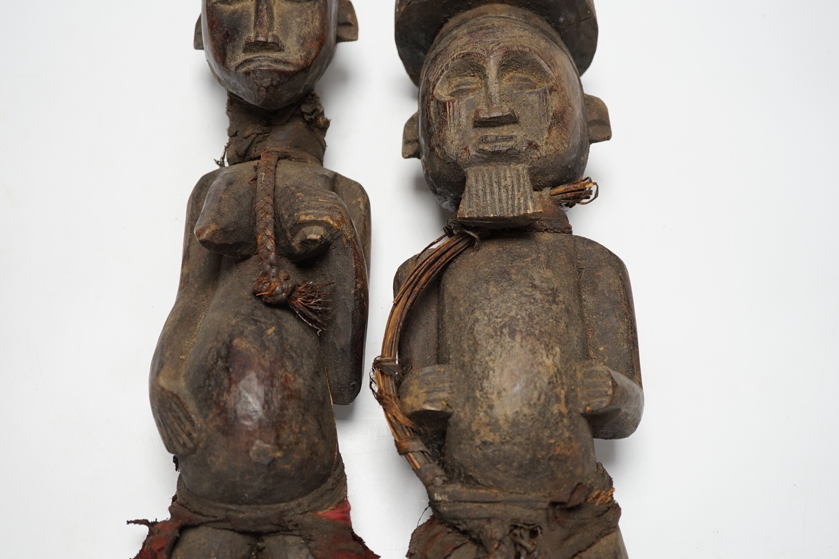 A pair of African tribal carved figures, tallest 53cm
